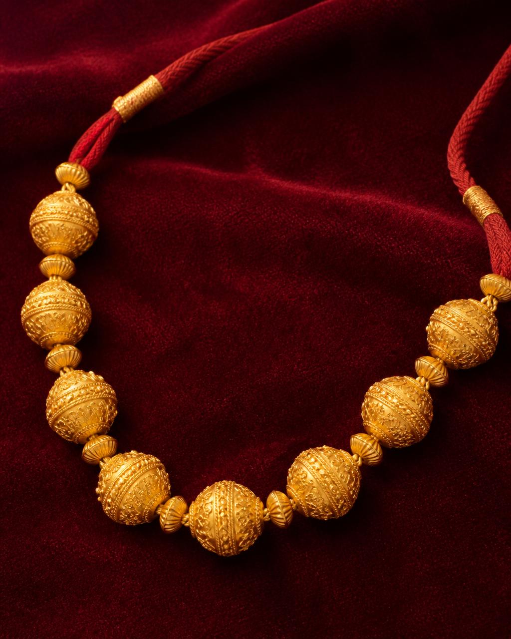 Traditional Nepali Naugedi in 22K gold on burgundy velvet