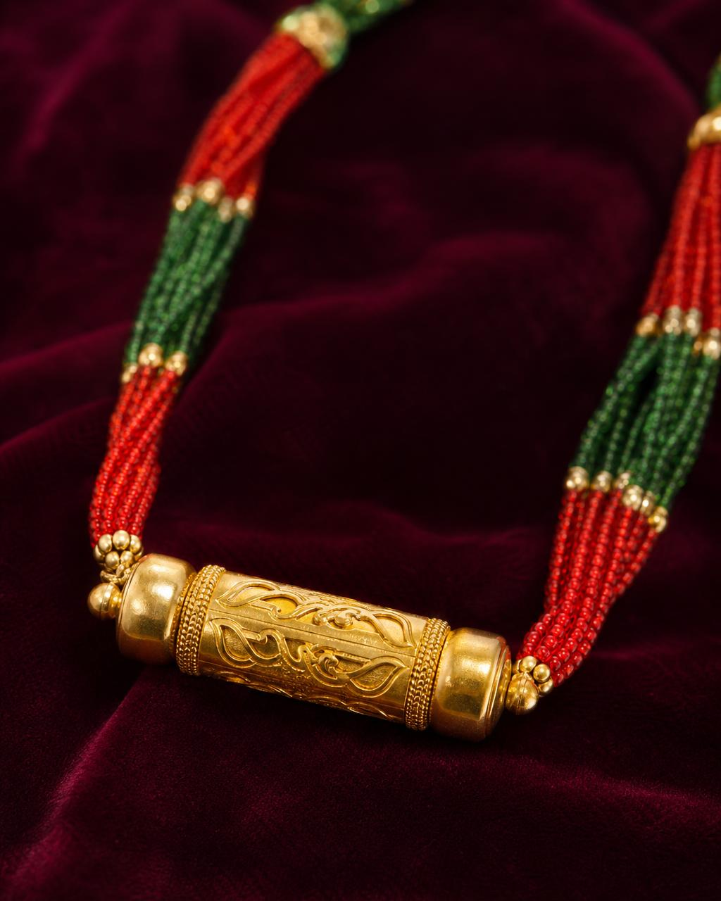 Traditional Nepali Tilhari in 22K gold on burgundy velvet